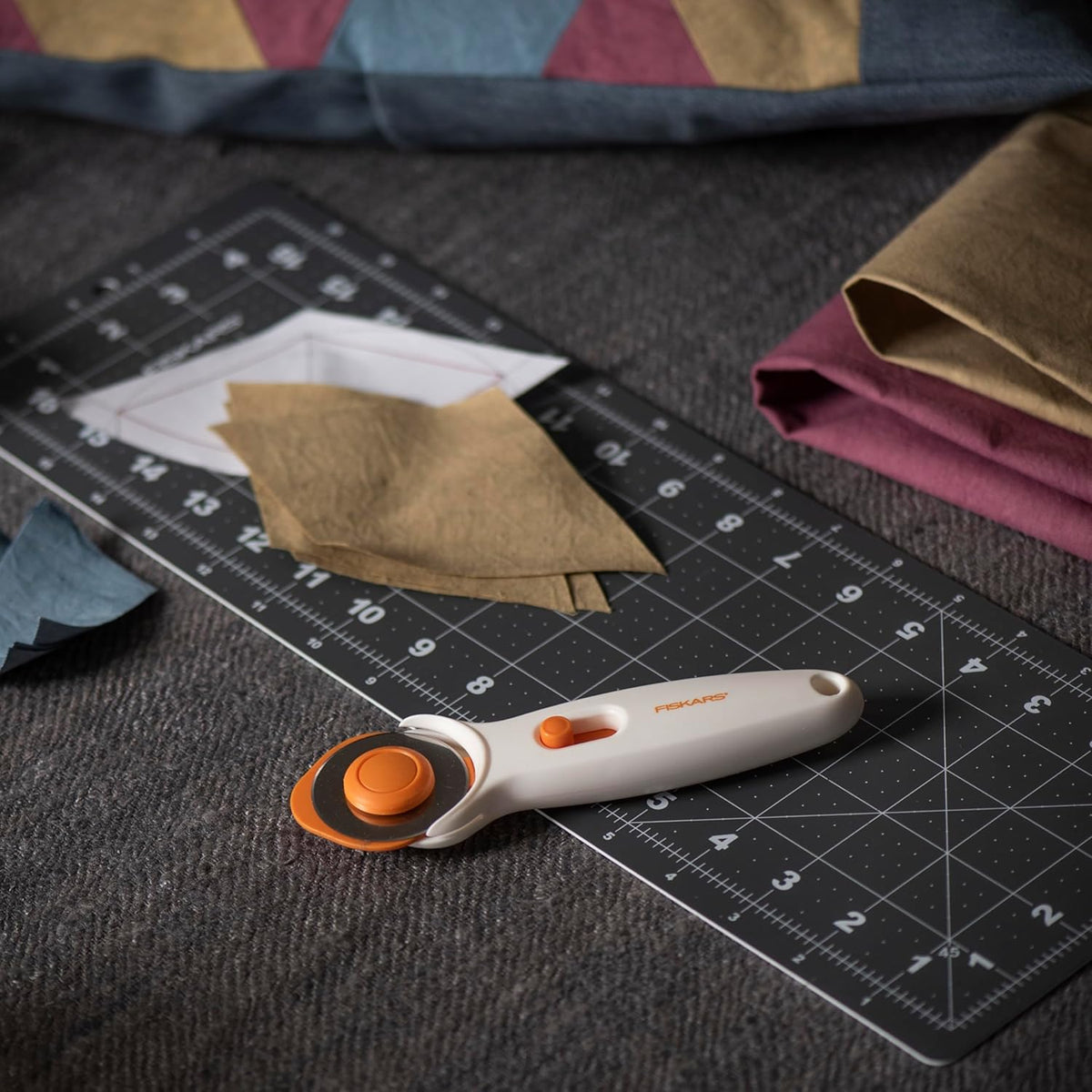 Fiskars 45mm Rotary Cutter for Fabric, Premium Steel Stick Fabric Cutter Cuts Through Multiple Layers, Right and Left Handed, Easy and Safe Blade
